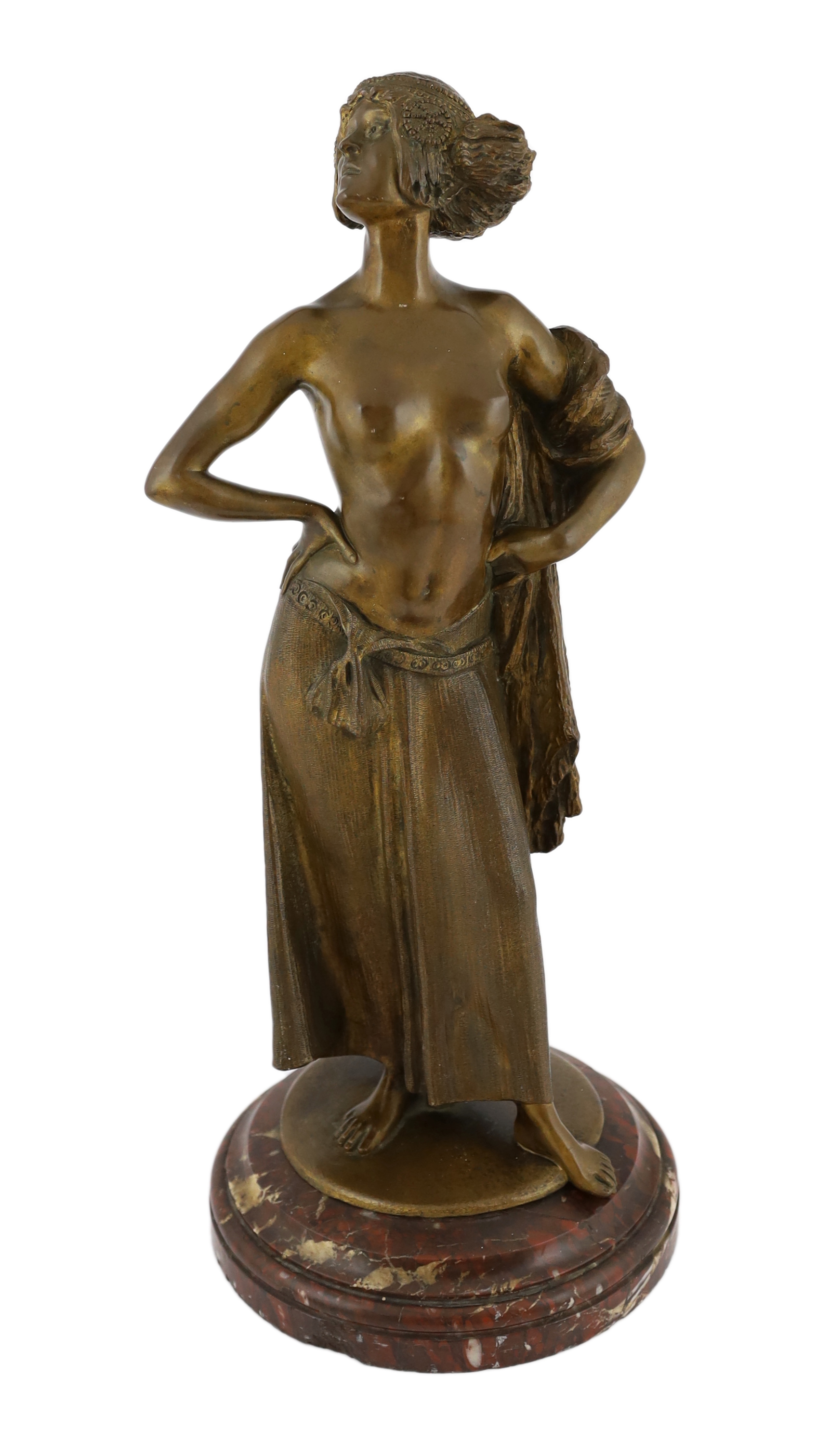 E. Leger - a bronze figure of an Eastern dancer standing with her hands on her hips, signed in the bronze, on rouge marble socle, 53cm high